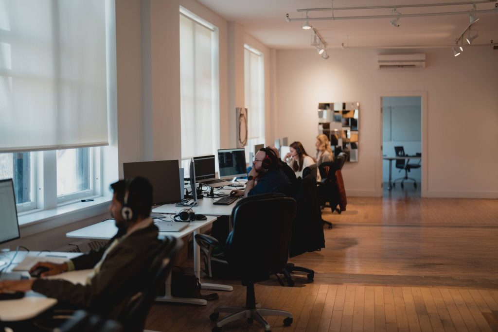 Four Eyes open-plan office with team members working at rows of desks