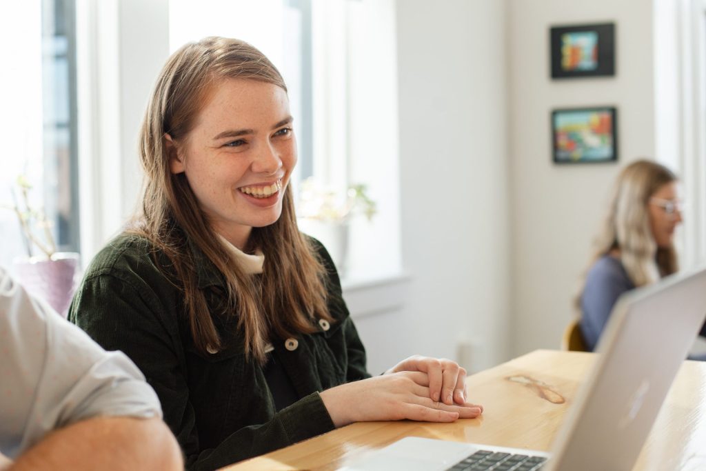 Four Eyes team member smiling during a meeting at the office table