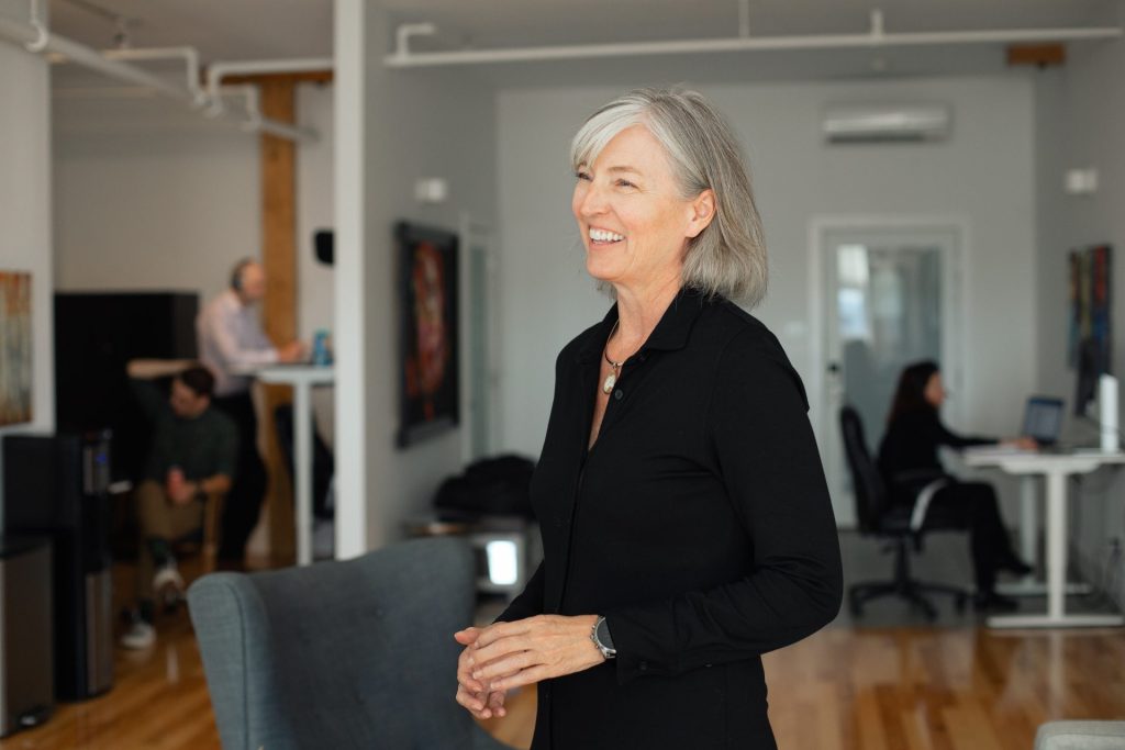 Four Eyes team member smiling in the open office
