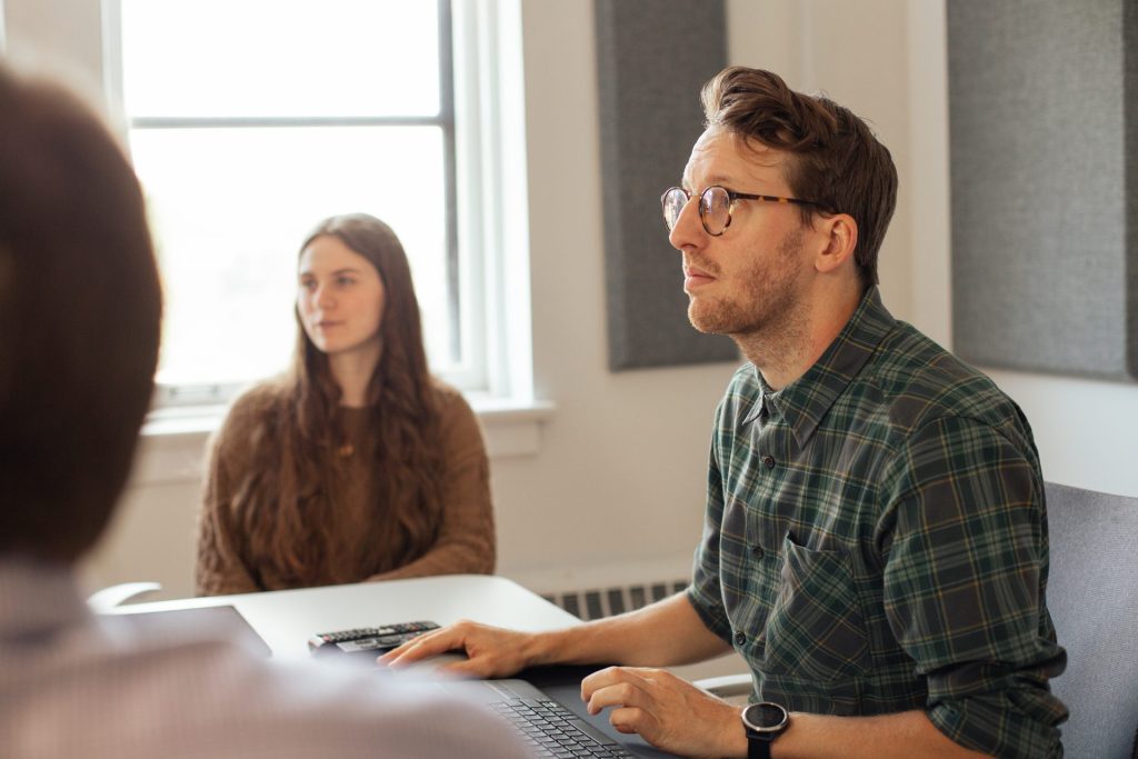Four Eyes colleagues in discussion during a team meeting