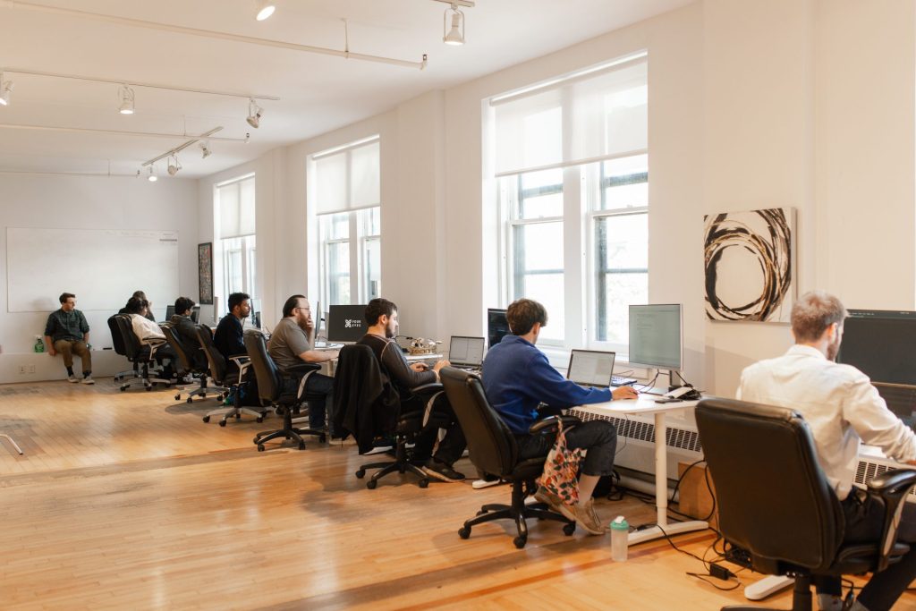 Four Eyes open-plan office with team members at rows of workstations