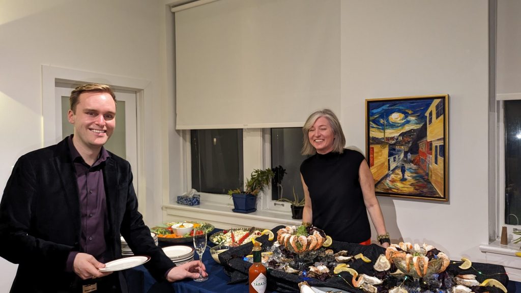 Four Eyes colleagues at a seafood buffet during an office celebration