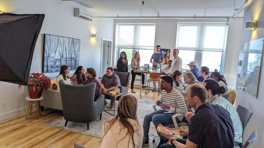 Four Eyes team gathered in the office lounge for a holiday celebration