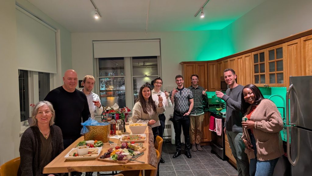 Four Eyes team gathered in the office kitchen for a celebration